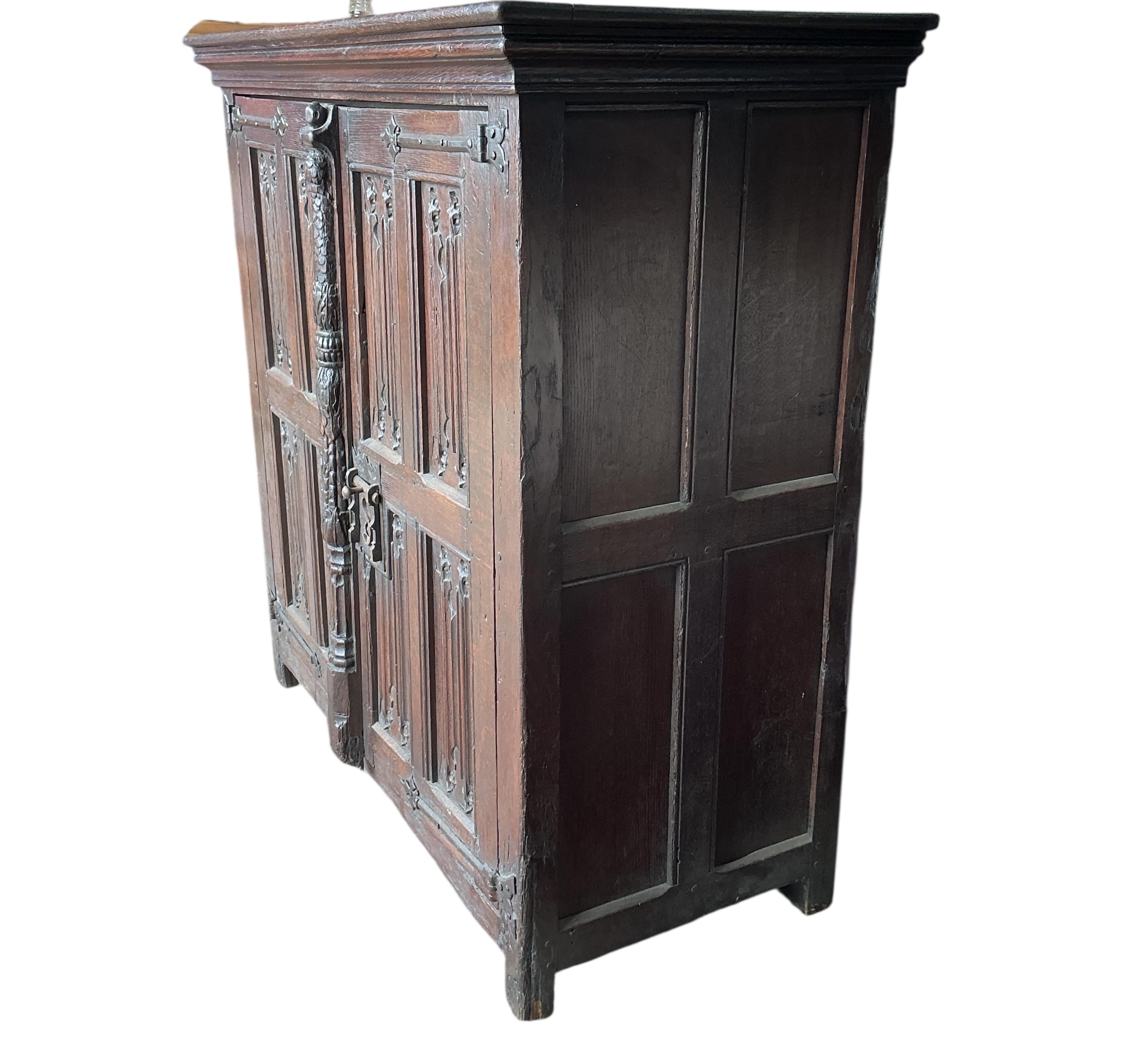 An 18th century and later French carved oak two door cabinet, width 115cm, depth 53cm, height 115cm